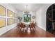 Bright dining room featuring hardwood floors, modern light fixture, and backyard view at 11827 S Montezuma Ct, Phoenix, AZ 85044