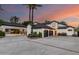 Stately home featuring an attached porte cochere, lush landscaping, and a spacious driveway for ample parking at 11827 S Montezuma Ct, Phoenix, AZ 85044