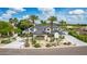 Stunning white home boasting meticulous landscaping, porte-cochere, and palm trees against a vibrant blue sky at 11827 S Montezuma Ct, Phoenix, AZ 85044