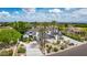 Expansive white home with a porte-cochere, mature landscaping, and palm trees, offering stunning curb appeal at 11827 S Montezuma Ct, Phoenix, AZ 85044