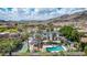 Stunning white home with desert landscaping, pool, and tennis court, offering luxurious outdoor living at 11827 S Montezuma Ct, Phoenix, AZ 85044