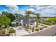 Beautiful white home featuring palm trees, a porte-cochere, and manicured landscaping, offering luxurious curb appeal at 11827 S Montezuma Ct, Phoenix, AZ 85044