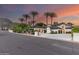 Stunning home with palm trees, lush landscaping, and expansive driveway offers curb appeal and luxury living at 11827 S Montezuma Ct, Phoenix, AZ 85044