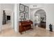 Hallway with a piano and decorative artwork leads to open dining room with plenty of natural light at 11827 S Montezuma Ct, Phoenix, AZ 85044