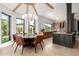 Open kitchen with exposed beam ceilings, granite counters, stainless appliances, and tile flooring at 11827 S Montezuma Ct, Phoenix, AZ 85044