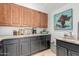 Kitchen featuring wood cabinets, granite counters, stainless sink, and tile backsplash at 11827 S Montezuma Ct, Phoenix, AZ 85044