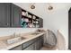 Functional kitchenette with dark cabinetry, sink, and countertop space for food prep at 11827 S Montezuma Ct, Phoenix, AZ 85044