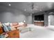 Inviting living room featuring a brown sofa, large TV, and a comfortable ottoman at 11827 S Montezuma Ct, Phoenix, AZ 85044