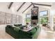 Bright living room with vaulted ceilings, stone fireplace, and a large green sectional sofa at 11827 S Montezuma Ct, Phoenix, AZ 85044