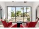 Bright sitting area with large glass doors leading to outdoor entertaining space with palms and pool at 11827 S Montezuma Ct, Phoenix, AZ 85044