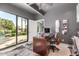 Bright home office with a desk, a large window overlooking a pool, and neutral accents at 11827 S Montezuma Ct, Phoenix, AZ 85044