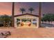 Beautiful patio cover with palm trees and a tennis court in the background at 11827 S Montezuma Ct, Phoenix, AZ 85044