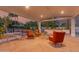 Covered patio area with outdoor furniture, lighting, and a tennis court in the background at 11827 S Montezuma Ct, Phoenix, AZ 85044