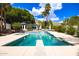 The backyard pool area has a diving board and spa, all surrounded by lush landscaping at 11827 S Montezuma Ct, Phoenix, AZ 85044