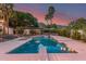Backyard oasis boasts a large swimming pool, diving board, and comfortable seating areas, all framed by lush landscaping at 11827 S Montezuma Ct, Phoenix, AZ 85044