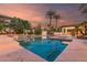 Beautiful backyard featuring a pool with custom tile, a seating area, and lush landscaping, perfect for relaxation and entertaining at 11827 S Montezuma Ct, Phoenix, AZ 85044