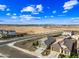 An aerial view shows the neighborhood and surrounding landscape with homes, streets, and expansive open land at 12472 W Kaler Dr, Glendale, AZ 85307