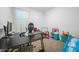 Bedroom space featuring an oversized gamer chair and desk for work or study at 12472 W Kaler Dr, Glendale, AZ 85307
