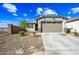 Charming single-story home featuring a low-maintenance yard and an attached two-car garage and covered front porch at 12472 W Kaler Dr, Glendale, AZ 85307