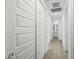 Hallway with white doors, clean lines, and neutral tile floors, creating a bright and spacious feel at 12472 W Kaler Dr, Glendale, AZ 85307