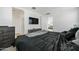 Well-lit main bedroom featuring hardwood flooring, television, and neutral paint at 12472 W Kaler Dr, Glendale, AZ 85307