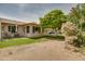Backyard with grassy lawn, beautiful flowering bushes, and shade trees, providing a serene outdoor space at 12548 W Parkwood Dr, Sun City West, AZ 85375
