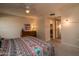 Comfortable bedroom featuring patterned bedding, dresser, and closet with easy access to the bathroom at 12548 W Parkwood Dr, Sun City West, AZ 85375