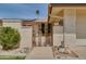 Charming front entrance with a decorative gate, desert landscaping, and inviting walkway to the front door at 12548 W Parkwood Dr, Sun City West, AZ 85375