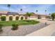 Well-maintained home exterior with lush green lawn, desert landscaping, solar panels and extended driveway at 12548 W Parkwood Dr, Sun City West, AZ 85375