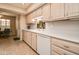 Bright kitchen area with white appliances, lots of cabinet space, tile floor and adjacent breakfast nook at 12548 W Parkwood Dr, Sun City West, AZ 85375