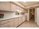 Well-lit kitchen features tile floors, spacious counters, white appliances, and ample cabinet storage at 12548 W Parkwood Dr, Sun City West, AZ 85375