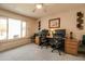 Bright office space featuring a large window, neutral walls, ceiling fan, and ample desk space for two at 12548 W Parkwood Dr, Sun City West, AZ 85375