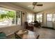Bright sunroom with comfortable seating, views of lush greenery, and a tranquil space for relaxation at 12548 W Parkwood Dr, Sun City West, AZ 85375