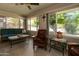 Relaxing sunroom with ample natural light, cozy furniture, and views of the beautiful outdoor scenery at 12548 W Parkwood Dr, Sun City West, AZ 85375