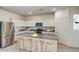 Bright kitchen with an island, stainless steel appliances, and white cabinets at 13198 E Verbina Ln, Florence, AZ 85132