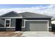 New home with gray exterior, stone accents, tile roof and a two-car garage at 13240 E Verbina Ln, Florence, AZ 85132