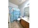 Charming bathroom with beach themed shower curtain, vanity and mirror at 15515 N 174Th Ave, Surprise, AZ 85388