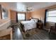 Bedroom with neutral walls, wood floors, ceiling fan, and a bright double window at 15515 N 174Th Ave, Surprise, AZ 85388