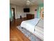 A generous-sized bedroom with hardwood floors, ceiling fan, and mounted TV at 15515 N 174Th Ave, Surprise, AZ 85388