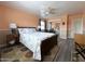Bedroom with neutral walls, wood floors, ceiling fan, and a bright window at 15515 N 174Th Ave, Surprise, AZ 85388