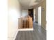 Bright hallway with wood floors leading to bedrooms and a barn door accent on stairway at 15515 N 174Th Ave, Surprise, AZ 85388