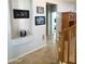 Hallway with niche, art decor and tile flooring leading to a door at 15515 N 174Th Ave, Surprise, AZ 85388