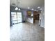 Open kitchen with a center island, adjacent to an dining area with sliding glass doors and tile flooring at 15515 N 174Th Ave, Surprise, AZ 85388