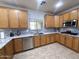 Well-lit kitchen featuring stainless steel appliances, granite counters, tile backsplash, and maple cabinets at 15515 N 174Th Ave, Surprise, AZ 85388