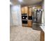 Kitchen featuring stainless steel appliances, maple cabinets and tile flooring at 15515 N 174Th Ave, Surprise, AZ 85388