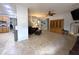 Living room with comfortable furniture, fireplace, media center, and tile flooring with an open view to the kitchen at 15515 N 174Th Ave, Surprise, AZ 85388