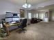 Open plan office area with built in desk, modern computer set-up and natural light at 15515 N 174Th Ave, Surprise, AZ 85388