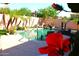 Beautiful backyard pool featuring rock waterfall, lush tropical landscaping, and comfortable lounge chairs at 15515 N 174Th Ave, Surprise, AZ 85388