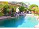 Backyard pool featuring lush tropical landscaping and patio furniture at 15515 N 174Th Ave, Surprise, AZ 85388