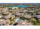 A scenic aerial view shows tan-roofed condos and community pool near a blue lake with a fountain in Fountain Hills at 16336 E Ridgeline Dr, Fountain Hills, AZ 85268